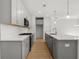 Modern kitchen with gray cabinets, quartz countertops, and stainless steel appliances at 714 Smokey Quartz Way, Kennesaw, GA 30144
