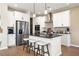 Modern kitchen with stainless steel appliances, white cabinets, and an island with seating at 714 Smokey Quartz Way, Kennesaw, GA 30144