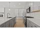 Modern kitchen features gray cabinets, quartz countertops, and stainless steel appliances at 714 Smokey Quartz Way, Kennesaw, GA 30144