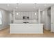 Modern kitchen with gray cabinets and a large quartz island at 714 Smokey Quartz Way, Kennesaw, GA 30144