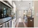 Modern kitchen with white cabinets, stainless appliances, and view to living room and door to back yard at 714 Smokey Quartz Way, Kennesaw, GA 30144