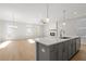 Open floor plan with modern kitchen island and spacious living room with fireplace at 714 Smokey Quartz Way, Kennesaw, GA 30144