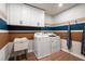 Well-lit laundry room with cabinets, washer, dryer, and accent wall at 714 Smokey Quartz Way, Kennesaw, GA 30144