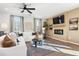 Cozy living room with a fireplace, TV, comfortable seating, and natural light at 714 Smokey Quartz Way, Kennesaw, GA 30144