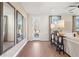 Living room with hardwood floors, modern lighting and three decorative mirrors with light entering from door and windows at 714 Smokey Quartz Way, Kennesaw, GA 30144