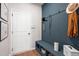 Welcoming mudroom with blue accent wall, hooks, and storage, perfect for organization at 714 Smokey Quartz Way, Kennesaw, GA 30144