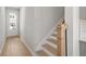 Staircase with light wood railing and hardwood floors at 714 Smokey Quartz Way, Kennesaw, GA 30144