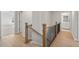 Light-filled upper hallway with wood flooring, black spindles, and access to bedrooms at 714 Smokey Quartz Way, Kennesaw, GA 30144