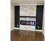 Living room with dark hardwood floors and fireplace with marble tiled facade at 1706 Alvarado Sw Ter, Atlanta, GA 30310