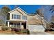 Two-story house with brick and siding exterior, a two-car garage, and landscaping at 1886 Carisbrook Pl, Austell, GA 30168