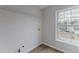 This laundry room features wood-look floors and a double hung window at 1886 Carisbrook Pl, Austell, GA 30168