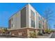 Modern three-story townhome with gray and white exterior, and attached garage at 2199 Lenox Ne Rd # 13, Atlanta, GA 30324