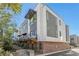 Stylish townhome showcasing a brick base, modern facade, and private balcony at 2199 Lenox Ne Rd # 13, Atlanta, GA 30324