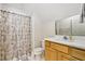 Bathroom with shower, vanity, and floral curtain at 135 Eagles Club Dr, Stockbridge, GA 30281