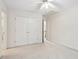 Spacious bedroom with double doors and ceiling fan at 135 Eagles Club Dr, Stockbridge, GA 30281