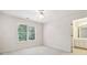 Bright bedroom with ceiling fan and adjacent bathroom at 135 Eagles Club Dr, Stockbridge, GA 30281