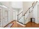 Two-story foyer with hardwood floors and elegant staircase at 135 Eagles Club Dr, Stockbridge, GA 30281