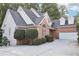Brick and stucco home with a two-car garage and lush landscaping at 135 Eagles Club Dr, Stockbridge, GA 30281