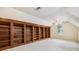 Large library with built-in wooden bookshelves at 135 Eagles Club Dr, Stockbridge, GA 30281