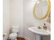 Convenient powder room with pedestal sink and toilet at 135 Eagles Club Dr, Stockbridge, GA 30281