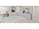 Bright bedroom featuring a white iron bed frame, dresser with decor, and ample closet space at 2458 Bayberry St, Acworth, GA 30101