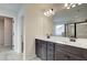 Bathroom featuring a dual vanity, framed mirror, and a shower with a glass enclosure at 4361 Portsbrook Ave, Snellville, GA 30039