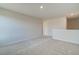 Neutral bonus room features carpet flooring, recessed lighting, and a half wall with an entry way to another part of the house at 4361 Portsbrook Ave, Snellville, GA 30039
