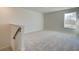 Upstairs loft area with carpet, natural light, and access to a staircase at 4361 Portsbrook Ave, Snellville, GA 30039