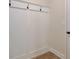 Mudroom features wood-look flooring, white wainscoting with coat hooks, trim, and a white door with black hardware at 4361 Portsbrook Ave, Snellville, GA 30039