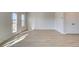 Bright, open room with wood-style flooring, double doors, and natural light at 4361 Portsbrook Ave, Snellville, GA 30039