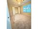 Bedroom with neutral carpet, a window, and an open closet with white doors at 571 Oak Vista Ct, Lawrenceville, GA 30044