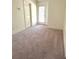 Bedroom with neutral walls and carpeting, and a door leading to the outside at 571 Oak Vista Ct, Lawrenceville, GA 30044