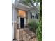 Inviting front entrance of home, featuring brick stairs, black railings, and a large window above the front door at 571 Oak Vista Ct, Lawrenceville, GA 30044