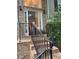 Inviting home entrance with brick stairs, black railings, and a glimpse into the foyer at 571 Oak Vista Ct, Lawrenceville, GA 30044