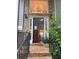 Inviting front entrance featuring a brick walkway and a glimpse of the foyer chandelier through a large window at 571 Oak Vista Ct, Lawrenceville, GA 30044