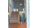 Open staircase featuring hardwood floors and light-blue walls with a view to the floor above at 571 Oak Vista Ct, Lawrenceville, GA 30044