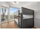 Bedroom featuring bunk beds, hardwood floors, and a large window with city views at 3325 Piedmont Ne Rd # 2407, Atlanta, GA 30305