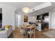 Inviting dining area with a chandelier, hardwood floors, and an open layout connecting to the kitchen at 3325 Piedmont Ne Rd # 2407, Atlanta, GA 30305