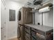 Convenient laundry room featuring a stacked washer and dryer and functional storage shelves at 3325 Piedmont Ne Rd # 2407, Atlanta, GA 30305