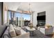 Cozy living room with plush seating, a large window with city views, and a modern entertainment center at 3325 Piedmont Ne Rd # 2407, Atlanta, GA 30305