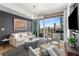 Bright living room with expansive windows offering stunning city views and stylish, comfortable furniture at 3325 Piedmont Ne Rd # 2407, Atlanta, GA 30305