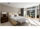 Bright main bedroom with access to a private balcony, plush bedding, and stylish furnishings at 3325 Piedmont Ne Rd # 2407, Atlanta, GA 30305