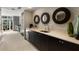 Modern wet bar featuring sleek cabinetry, stone countertops, and stylish round mirrors at 3325 Piedmont Ne Rd # 2407, Atlanta, GA 30305