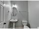 Small bathroom with pedestal sink and toilet at 686 Village Field Ct, Suwanee, GA 30024