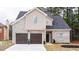 Two-story house with brick and siding, two-car garage, and landscaping at 3405 Summer Brooke Way, Union City, GA 30291