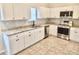 Modern kitchen with white cabinets, granite counters, and stainless steel appliances at 3405 Summer Brooke Way, Union City, GA 30291