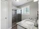 Modern bathroom with a walk-in shower and granite countertop at 1385 Kenilworth Sw Dr, Atlanta, GA 30310