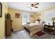Bright bedroom featuring a double bed, ceiling fan, and ample natural light at 1385 Kenilworth Sw Dr, Atlanta, GA 30310