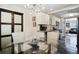 Glass-topped dining table with four chairs, in an open floor plan at 1385 Kenilworth Sw Dr, Atlanta, GA 30310