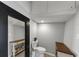 Cozy half-bathroom with a toilet, small sink, and decorative storage shelves on either side at 2507 Maple St, Atlanta, GA 30344